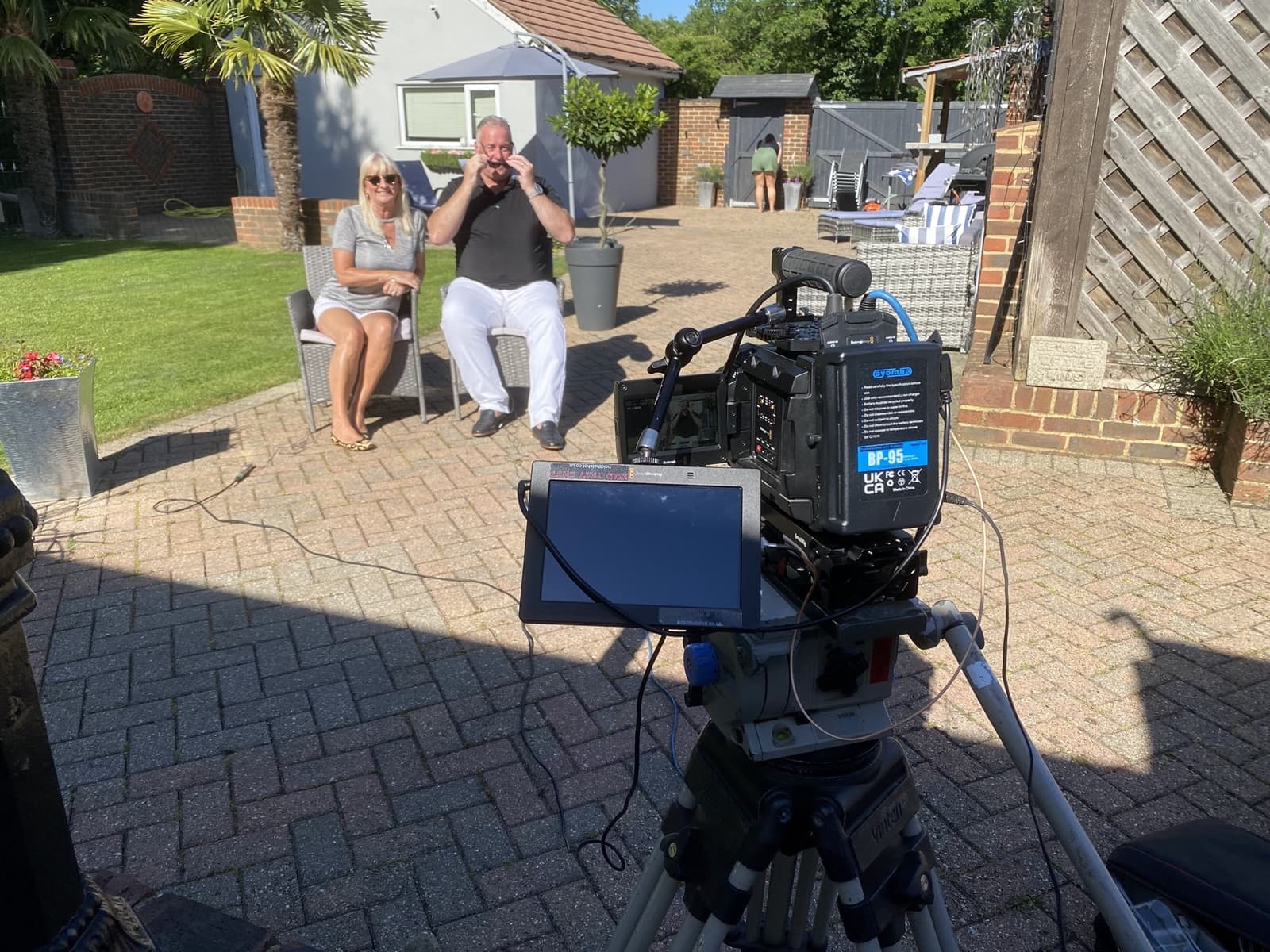 Two clients filmed for a testimonial in their garden