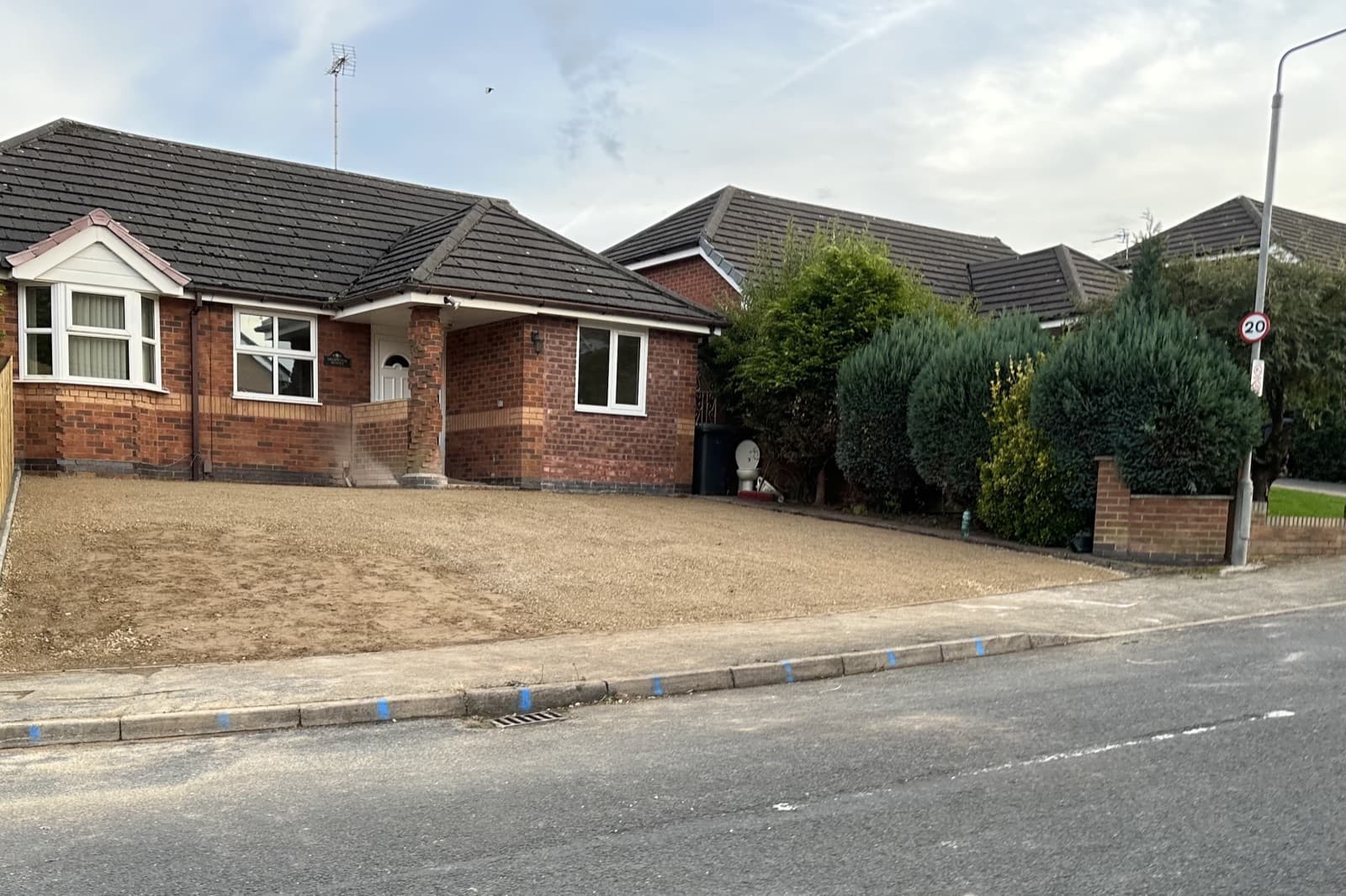A detached brick bungalow with a new gravel drive